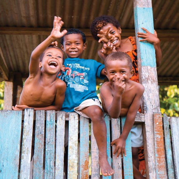 Photo of local kids smiling at camera