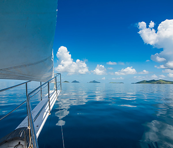 Photo of yacht sailing through calm Fijian ocean